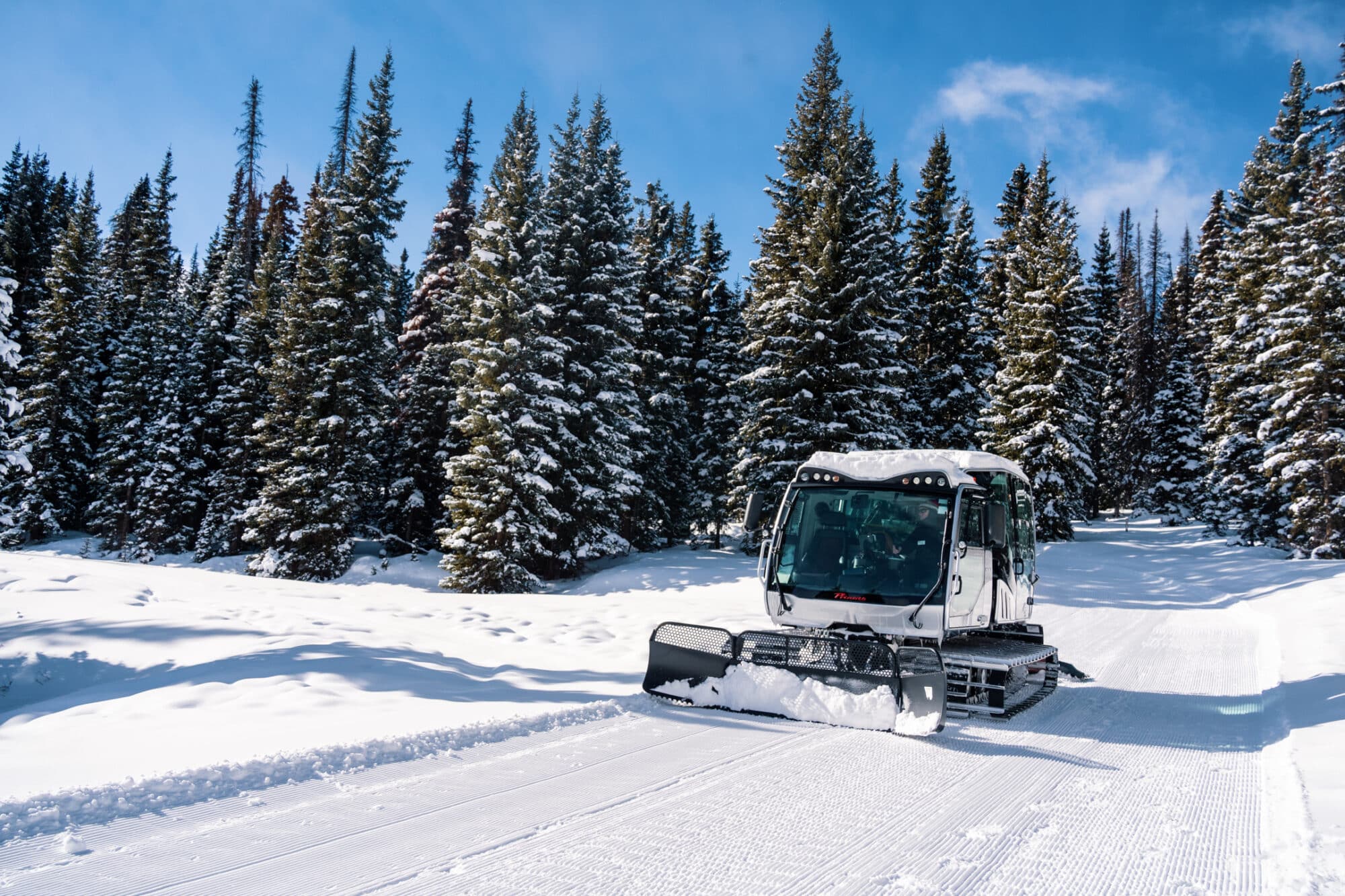 Scenic snowcat drives down snow road to scenic overlook