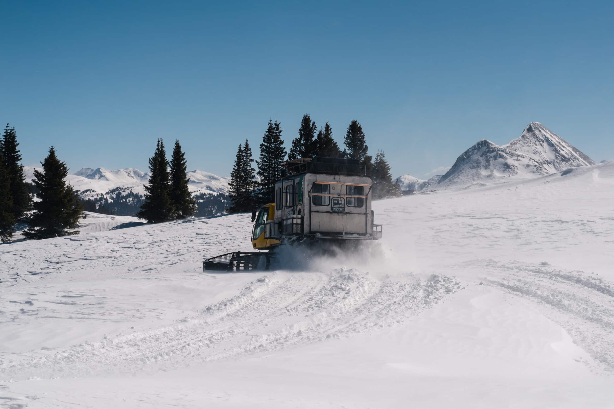 Snowcat traversing terrain