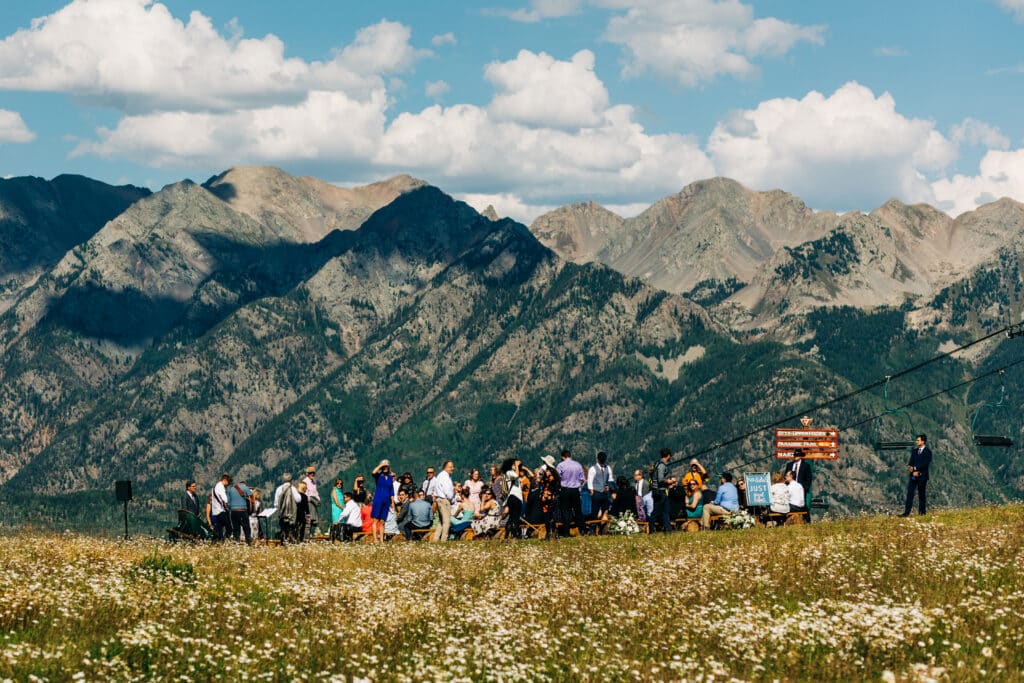 a wedding party gathered in a high alpine meadow