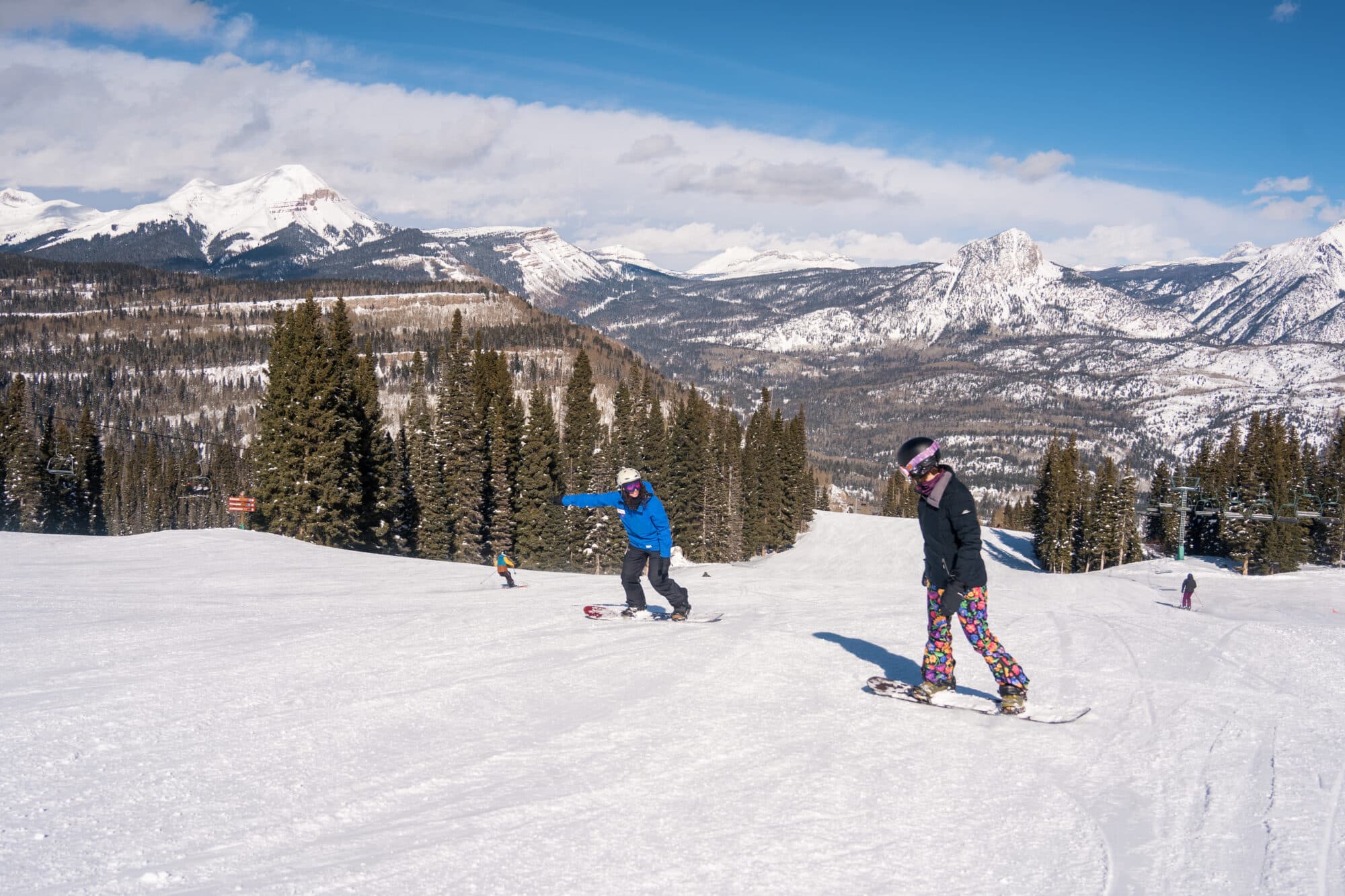 Snowboard instructor point the way into a toe side turn