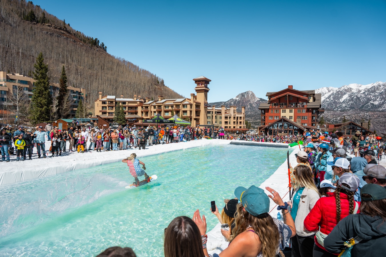 Snowboarder skims across the pond a Purgatory's biggest spring break party