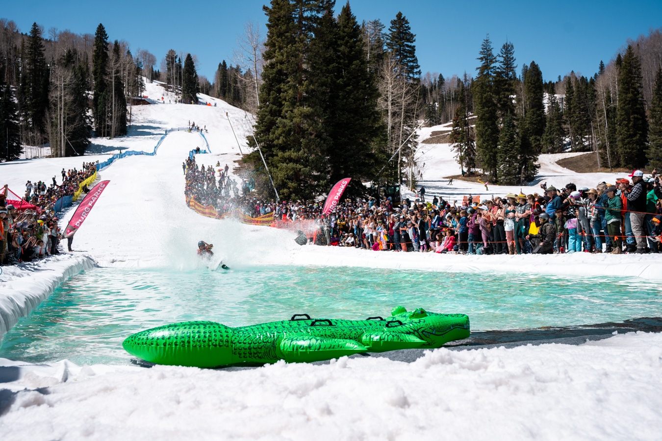 Skier attempts skimming across the pond at Purgatory's annual Pong Skim