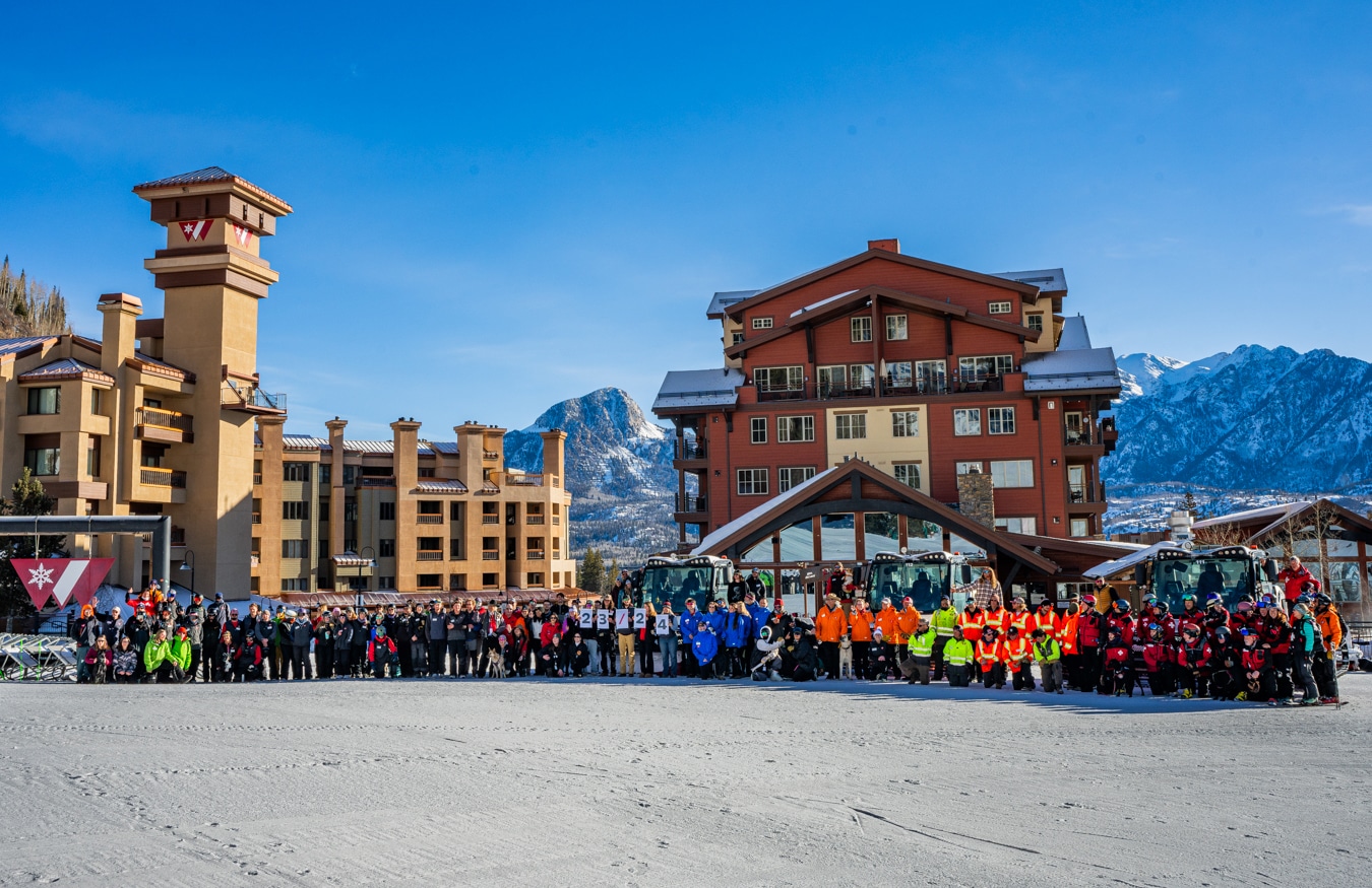 Winter 23/24 employee group photo on the beach area of Purgatory Resort