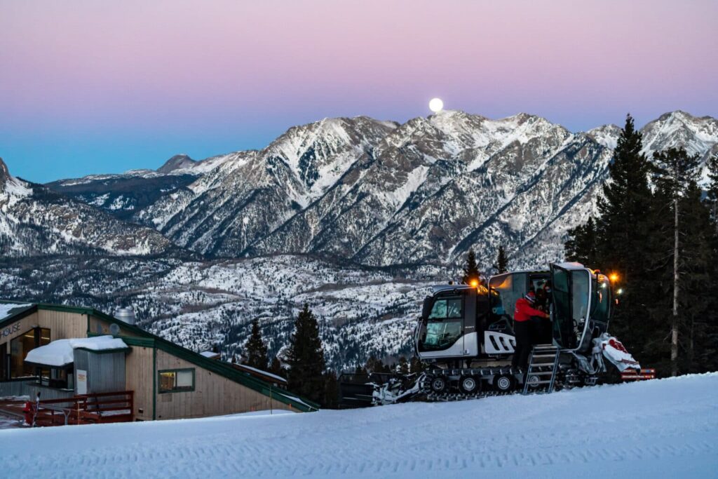 Snowcat against the alpine glow